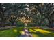 Scenic garden path lined with lush flowers and majestic trees, offering a serene escape at 3154 Shorecrest Bay Dr., Murrells Inlet, SC 29576