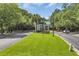Gated community entrance showcasing meticulously maintained grounds, with patriotic flags at 3154 Shorecrest Bay Dr., Murrells Inlet, SC 29576