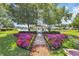 Picturesque gazebo by the lake featuring colorful flowers and well-manicured landscaping at 3154 Shorecrest Bay Dr., Murrells Inlet, SC 29576