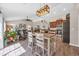 Bright and open kitchen-living area with modern lighting, wood floors, and stainless-steel appliances at 3154 Shorecrest Bay Dr., Murrells Inlet, SC 29576