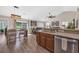 Open-concept kitchen with breakfast bar, wooden cabinets, stainless steel dishwasher, and adjacent dining area at 3154 Shorecrest Bay Dr., Murrells Inlet, SC 29576