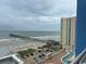 Beautiful beach view from balcony of home; beach pier, condo building and parking visible at 3601 N Ocean Blvd. # 1139, North Myrtle Beach, SC 29582
