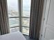 Bedroom view showcasing large windows offering panoramic views of the city and the beautiful coastline at 3601 N Ocean Blvd. # 1139, North Myrtle Beach, SC 29582
