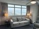 Relaxing living area featuring a comfortable sofa and chairs, offering picturesque views of the ocean and the city at 3601 N Ocean Blvd. # 1139, North Myrtle Beach, SC 29582