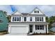 Charming two-story home with white siding, black shutters, and an attached two-car garage at 383 Wingspan Ct., Myrtle Beach, SC 29588