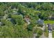 An aerial view showcases this brick home nestled among lush trees, a golf course, and nearby amenities at 3975 River Hills Dr., Little River, SC 29566