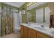 This bathroom features a double vanity, a shower and tub combo with light green walls at 3975 River Hills Dr., Little River, SC 29566