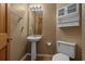 Powder room features a pedestal sink, mirror, toilet, vanity and wood look flooring at 3975 River Hills Dr., Little River, SC 29566