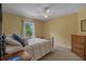 This bedroom has carpet, a ceiling fan and a large window with tree views at 3975 River Hills Dr., Little River, SC 29566