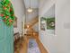 Inviting foyer with wood floors, staircase, and an open view to a dining area showcasing the home's layout at 3975 River Hills Dr., Little River, SC 29566