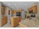 Kitchen featuring granite countertops, wooden cabinets, stainless steel appliances, and a central island at 3975 River Hills Dr., Little River, SC 29566