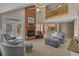Spacious living room with vaulted ceiling, a fireplace, a ceiling fan, and a staircase to the upper level at 3975 River Hills Dr., Little River, SC 29566