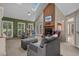 Open living room features a skylight, ceiling fan, brick fireplace, and comfortable seating area at 3975 River Hills Dr., Little River, SC 29566