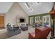 Bright living room boasts skylights, vaulted ceiling, large windows, and a comfortable seating arrangement at 3975 River Hills Dr., Little River, SC 29566