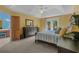 This bedroom features a tray ceiling, ceiling fan, and private access to the balcony and ensuite at 3975 River Hills Dr., Little River, SC 29566