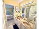 Bathroom with double vanity, marble countertops, and a glimpse into connecting rooms at 404 29Th Ave. N, North Myrtle Beach, SC 29582