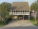 Inviting raised beach house offering ample covered parking and outdoor lounge space at 404 29Th Ave. N, North Myrtle Beach, SC 29582