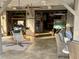 Garage featuring unique swinging chairs, comfortable seating, and golf carts, creating a recreational hangout space at 404 29Th Ave. N, North Myrtle Beach, SC 29582