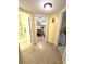 Hallway with wood flooring, leading to rooms with yellow walls and coastal decorations at 404 29Th Ave. N, North Myrtle Beach, SC 29582