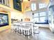 Stylish kitchen featuring a white kitchen island with stool seating, stainless steel appliances, and a window bench at 404 29Th Ave. N, North Myrtle Beach, SC 29582