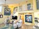 Bright living room features a stairway, ceiling fan, modern furniture, and decorative wall art at 404 29Th Ave. N, North Myrtle Beach, SC 29582