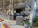 Comfortable outdoor seating area with stylish wicker furniture, a unique birdcage planter, and a lush garden view at 404 29Th Ave. N, North Myrtle Beach, SC 29582