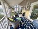 Charming screened porch with wicker seating, tropical-themed pillows, and a decorative mermaid wall art for a coastal vibe at 404 29Th Ave. N, North Myrtle Beach, SC 29582