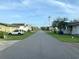 Quiet street with well-maintained lawns and various home styles under a blue sky at 404 29Th Ave. N, North Myrtle Beach, SC 29582