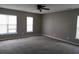 Bedroom featuring three large windows that let in natural light and neutral colored walls and carpet at 433 Emerson Dr., Myrtle Beach, SC 29579