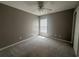 Bedroom featuring neutral paint, white ceiling fan, and window letting in natural light at 433 Emerson Dr., Myrtle Beach, SC 29579