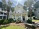 Charming two-story home featuring a front porch framed by palm trees and lovely landscaping at 433 Emerson Dr., Myrtle Beach, SC 29579