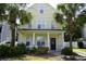 Inviting two-story home with classic columns, a cozy porch, and a beautifully landscaped yard with palm trees at 433 Emerson Dr., Myrtle Beach, SC 29579