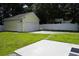 Detached one-car garage featuring a white door, adjacent to the concrete patio and grassy backyard at 433 Emerson Dr., Myrtle Beach, SC 29579