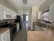 Galley kitchen featuring stainless steel appliances, white cabinetry, and ample counter space at 433 Emerson Dr., Myrtle Beach, SC 29579