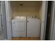 Laundry room with a side-by-side white washer and dryer and a wire shelf at 433 Emerson Dr., Myrtle Beach, SC 29579