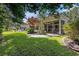 Expansive backyard showcases a lovely screened porch, patio, and lush green lawn shaded by mature trees at 4610 Fringetree Dr., Murrells Inlet, SC 29576
