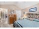 A bright bedroom features a metal bed frame, light-colored walls, and a glimpse into an adjacent room at 4610 Fringetree Dr., Murrells Inlet, SC 29576