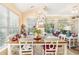 Bright dining room with a chandelier, large windows, and a wooden dining table at 4610 Fringetree Dr., Murrells Inlet, SC 29576