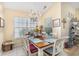 Bright dining room with a chandelier, large windows, and a wooden dining table at 4610 Fringetree Dr., Murrells Inlet, SC 29576