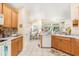 Bright kitchen featuring tile floors and backsplash, wood cabinets, and stainless appliances at 4610 Fringetree Dr., Murrells Inlet, SC 29576