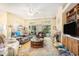 Comfortable living room with a fireplace, large windows, and sliding glass doors at 4610 Fringetree Dr., Murrells Inlet, SC 29576