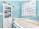 Calm main bathroom featuring a tub, natural lighting, and storage shelving at 4610 Fringetree Dr., Murrells Inlet, SC 29576