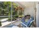This screened porch offers a tranquil outdoor space with comfortable seating and lush garden views at 4610 Fringetree Dr., Murrells Inlet, SC 29576
