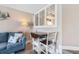 Cozy living room featuring a comfortable blue sofa, nautical decor, and a dining table for two at 4800 Ocean Blvd. S # 1119, North Myrtle Beach, SC 29582