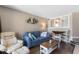 Bright living room with a blue sofa, white armchair, and a dining table, perfect for relaxing at 4800 Ocean Blvd. S # 1119, North Myrtle Beach, SC 29582