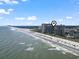 Wide aerial shot of the condo complex and beach showing many beachgoers at 4800 S Ocean Blvd. # 520, North Myrtle Beach, SC 29582
