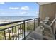Relaxing balcony with seating, and a panoramic view of the beach and ocean at 4800 S Ocean Blvd. # 520, North Myrtle Beach, SC 29582