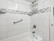 Contemporary tiled shower with grab bar and storage caddy at 4800 S Ocean Blvd. # 520, North Myrtle Beach, SC 29582