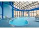 Bright indoor pool beneath large skylight features ample seating and shallow end at 4800 S Ocean Blvd. # 520, North Myrtle Beach, SC 29582