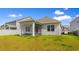 A well-maintained backyard featuring a covered patio, perfect for outdoor relaxation at 490 Calhoun Falls Dr., Myrtle Beach, SC 29579